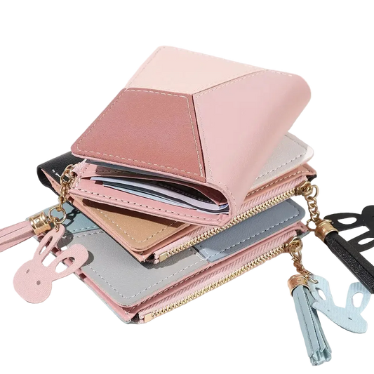 Pink wallet with tassel charm on a white background