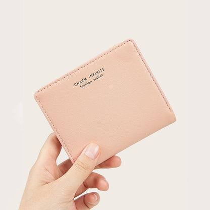 Pink wallet held by a hand