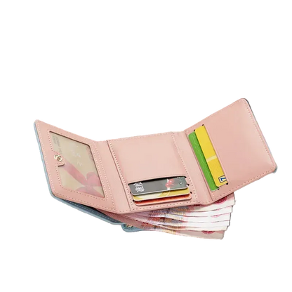 Pink wallet with cards on a magazine with sunglasses and floral design in the background
