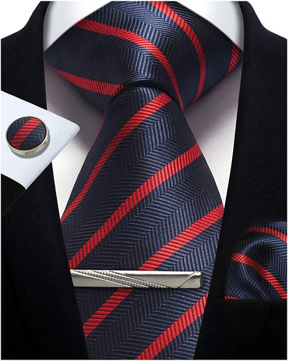 Navy and red striped tie with matching cufflinks and tie clip on a black suit jacket.