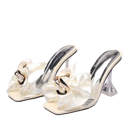 White high-heeled shoes with decorative ribbons