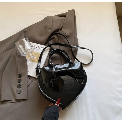 Black carauana-lovely-shoulder-bag-heart with a bow design